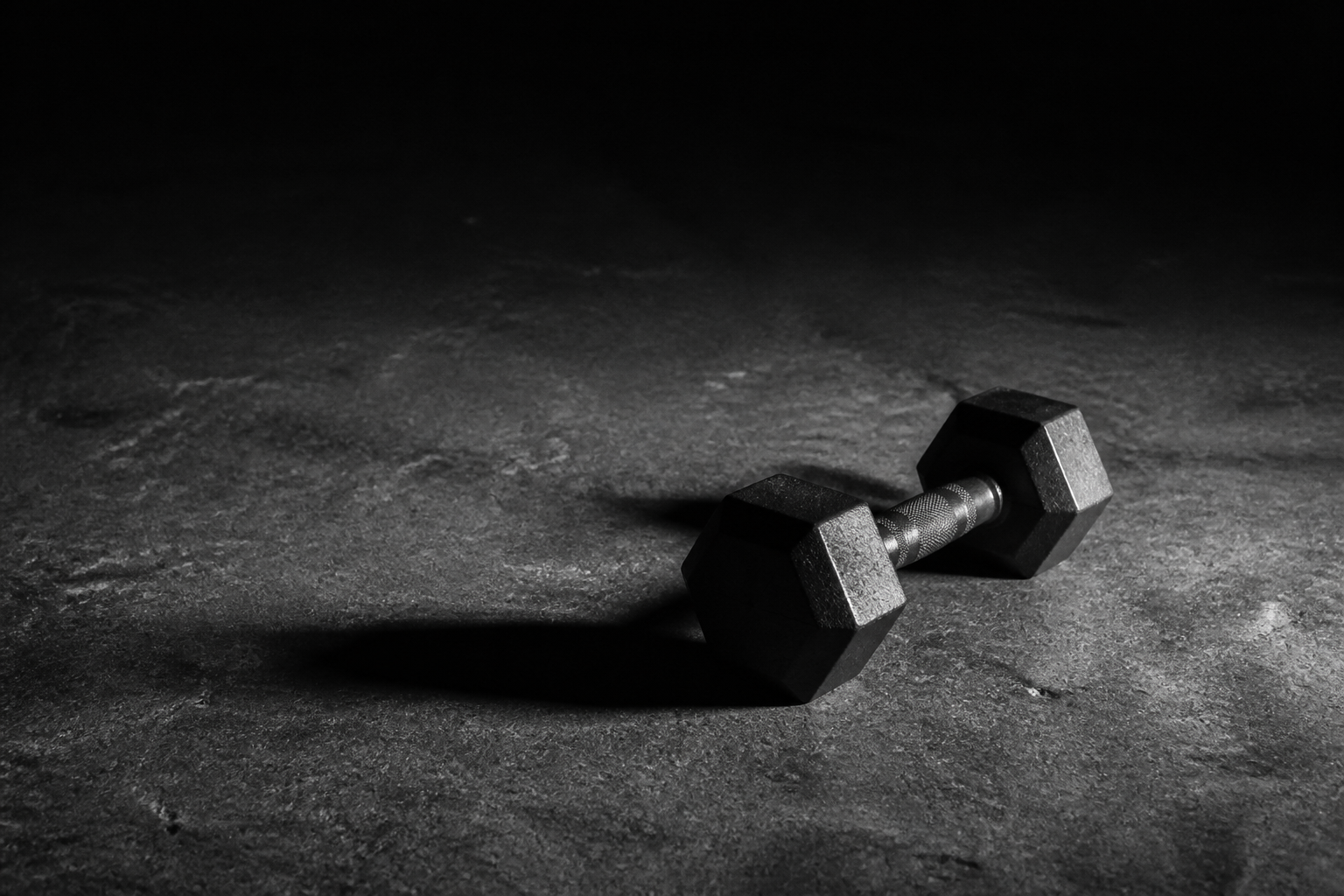 Dumbbell on the floor in dramatic light